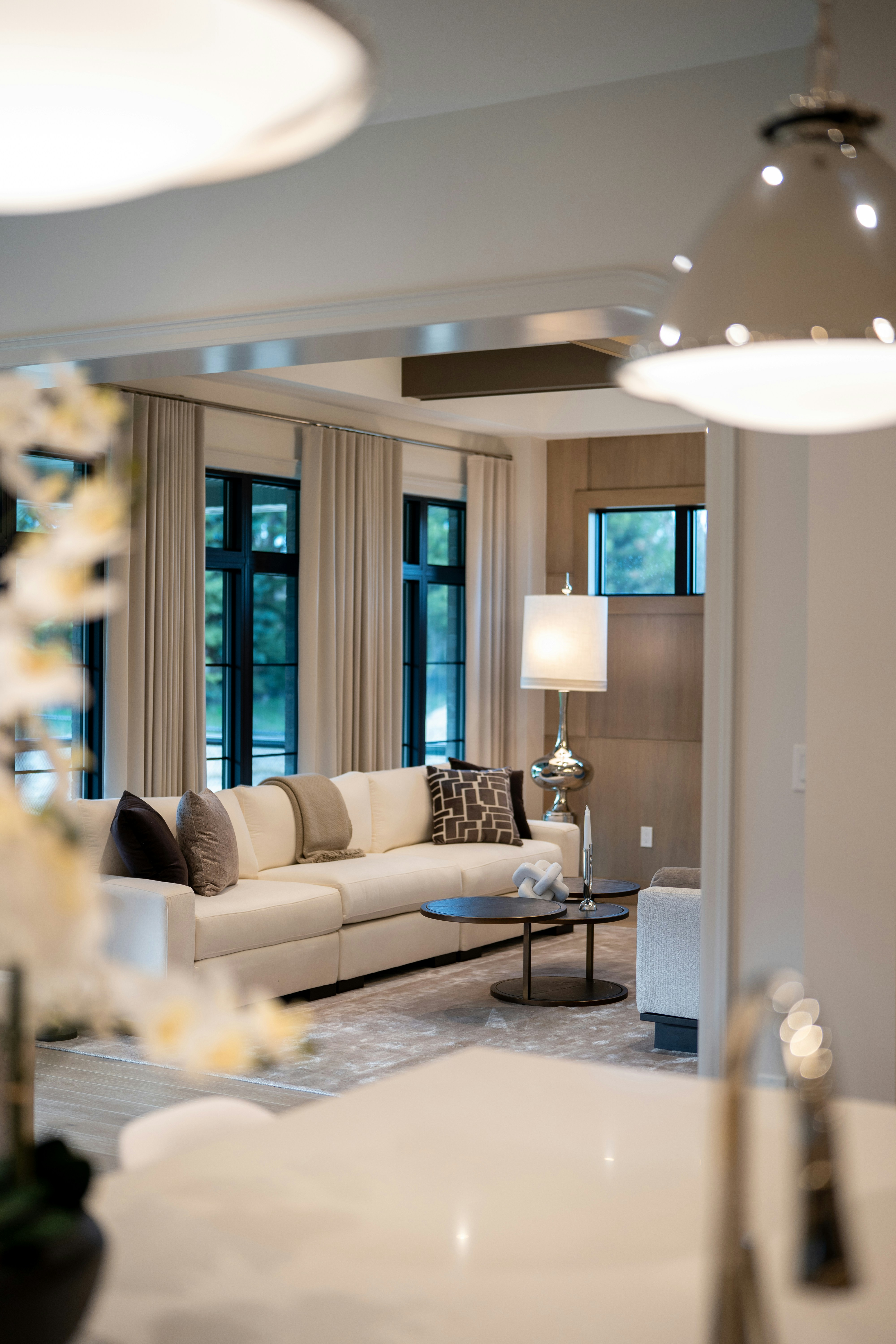 Staged open-plan living space with neutral tones and designer furniture