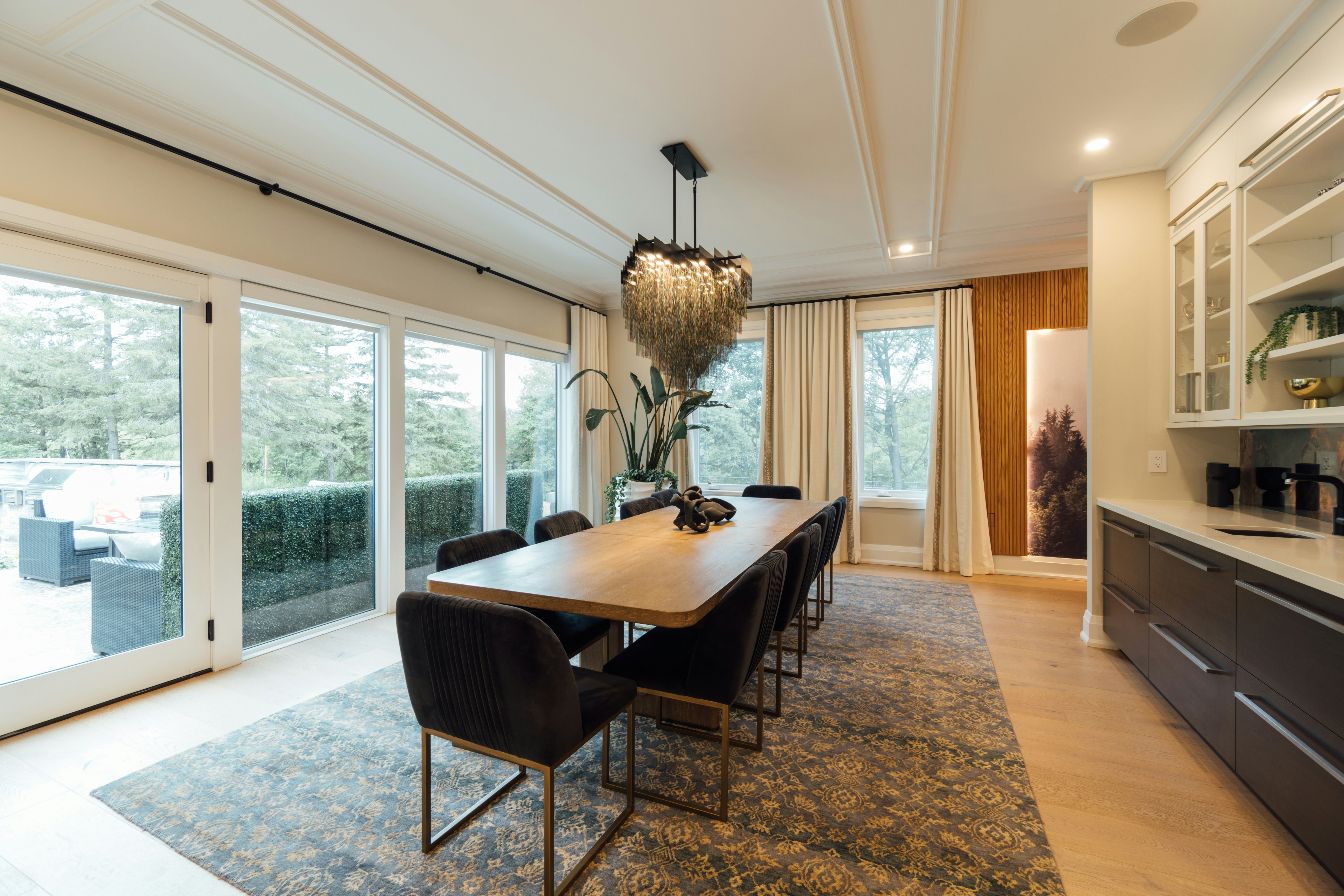 Elegantly staged dining room with large windows and statement chandelier